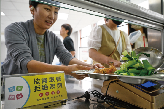 2025年6月10日，職工在安徽省合肥市廬陽區亳州路街道食堂就餐。食堂通 過張貼宣傳海報等方式，引導職工厲行節約、杜絕浪費。